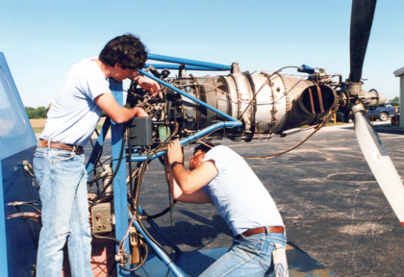 Aviation students working on a Turboprop engine stand