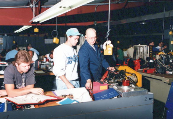 Technical instructor and students in the electronics lab