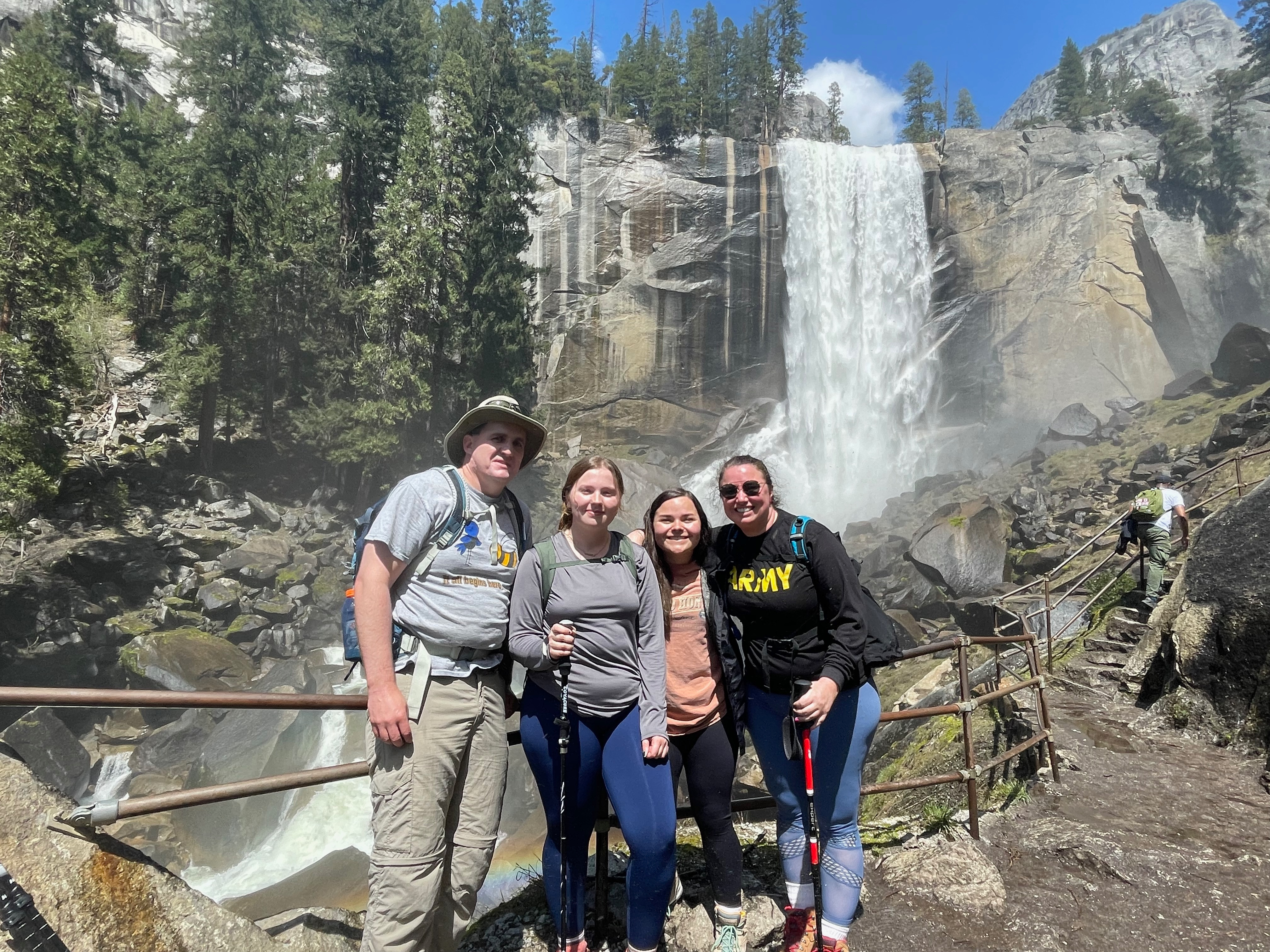 VU students and VU professors standing in front of a waterfall during the Biology Club's trip to California.
