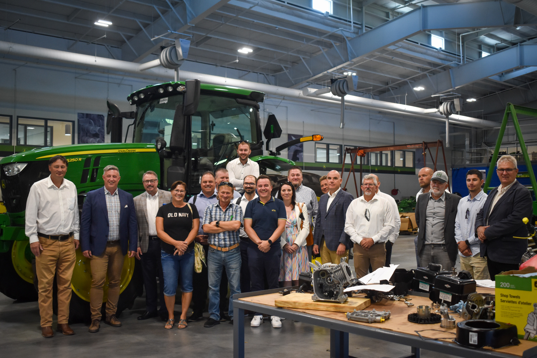Delegation of Hungarian agriculture officials and experts in front of a John Deere tractor at the VU Agricultural Center