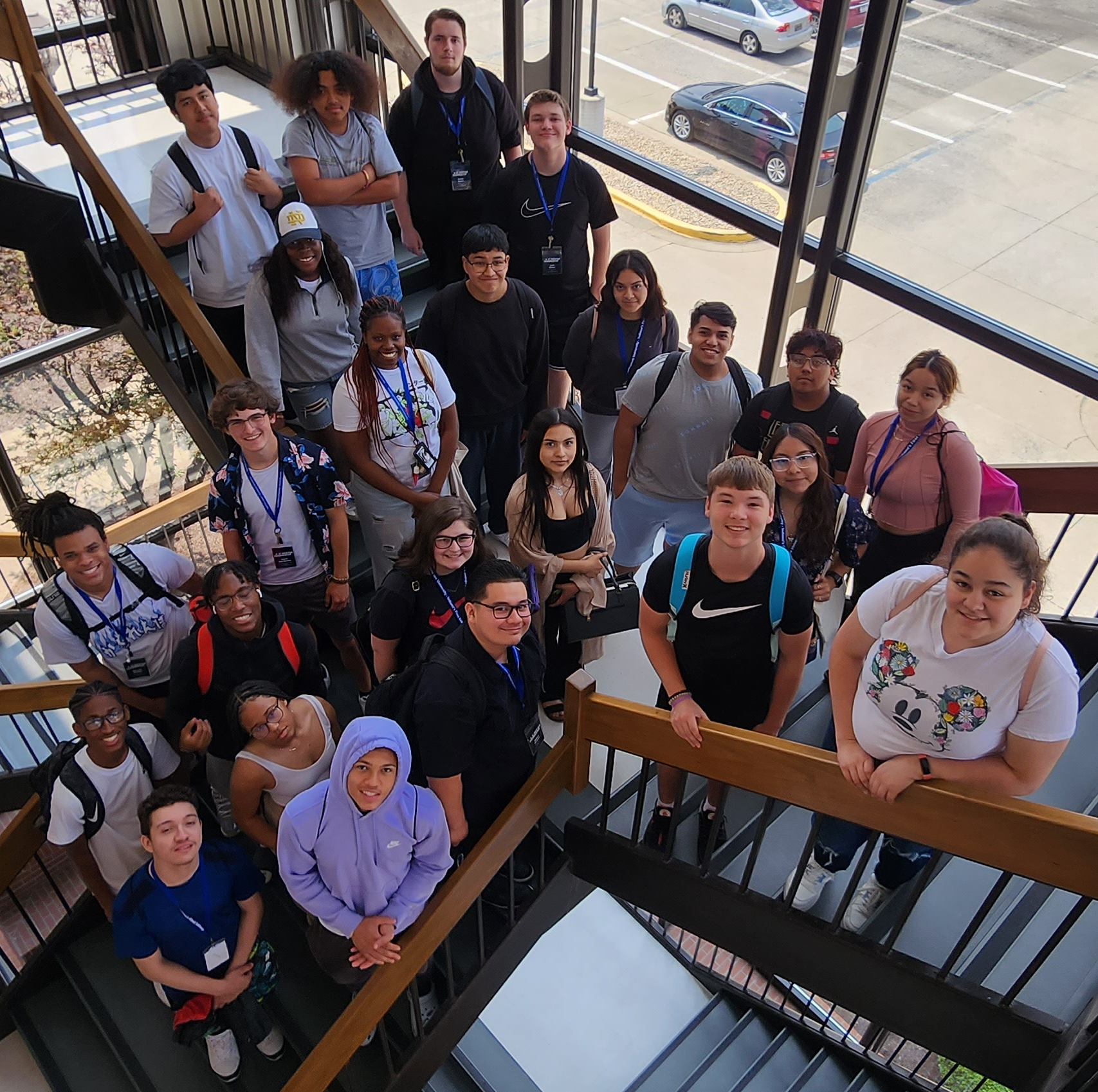 Students in Entrepreneurship Unlocked posing for a photograph on the stairs of the Wathen Business Building