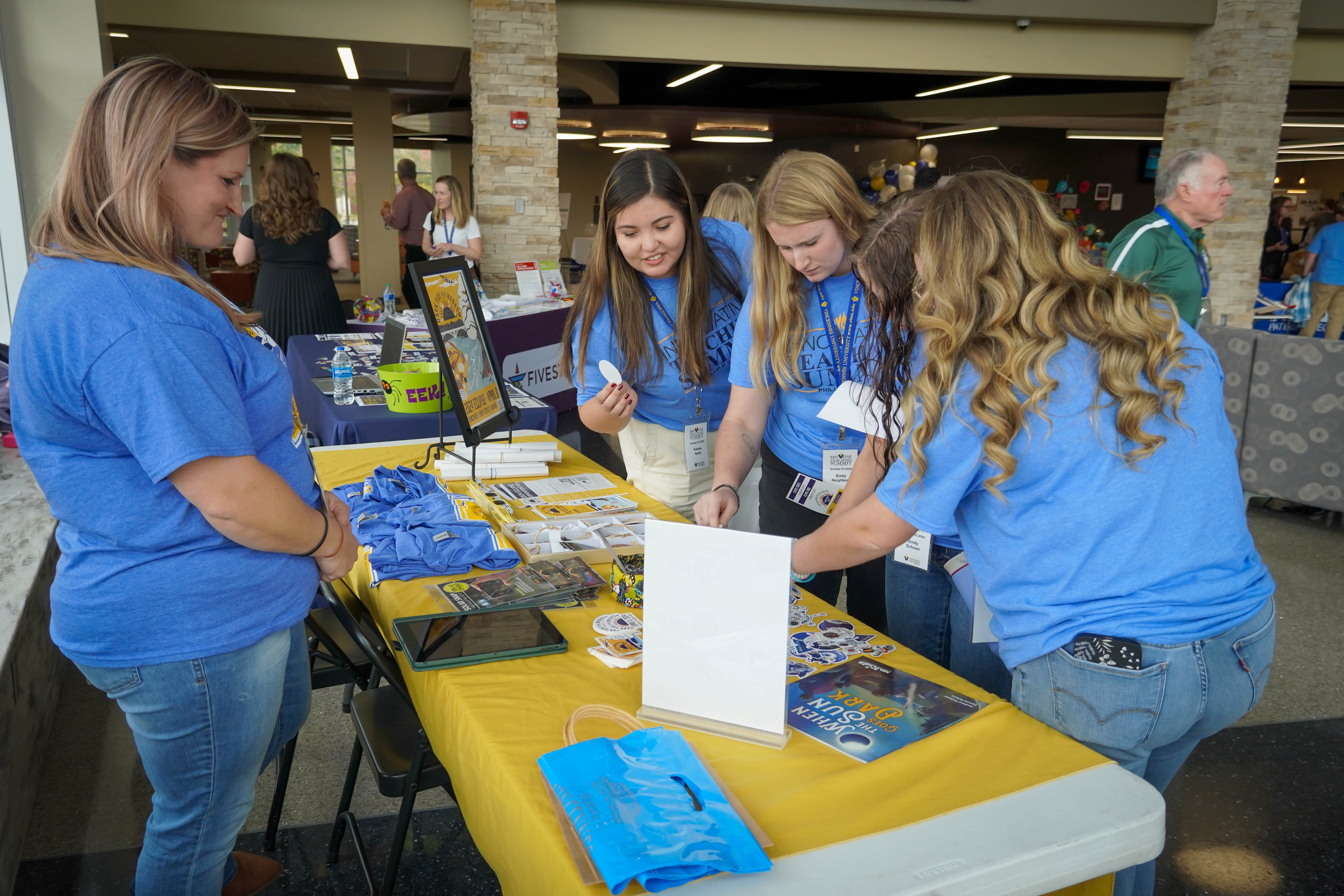 Female VU students browse items at a table at the Technology Playground