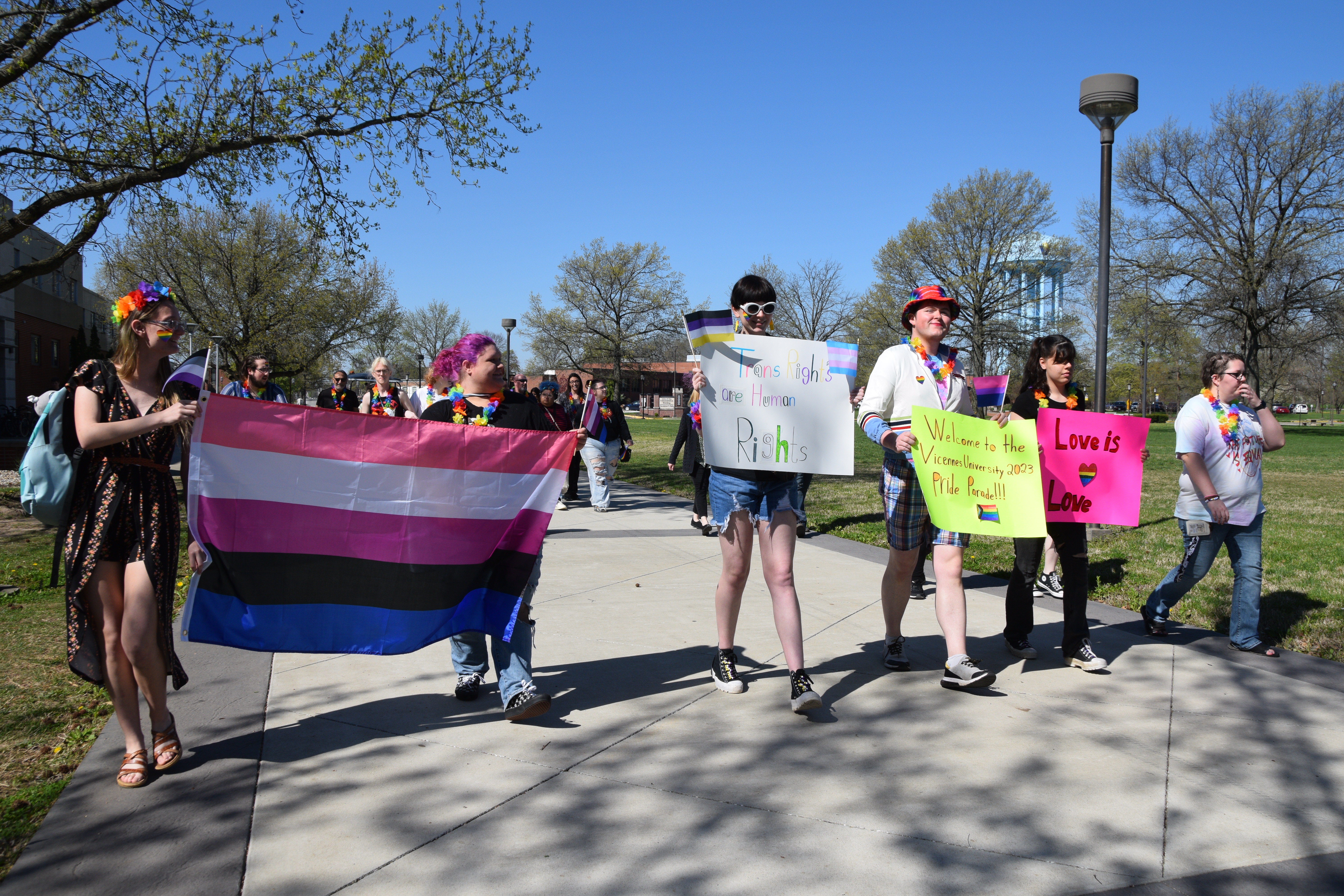 VU students carrying supportive signs and colorful flags