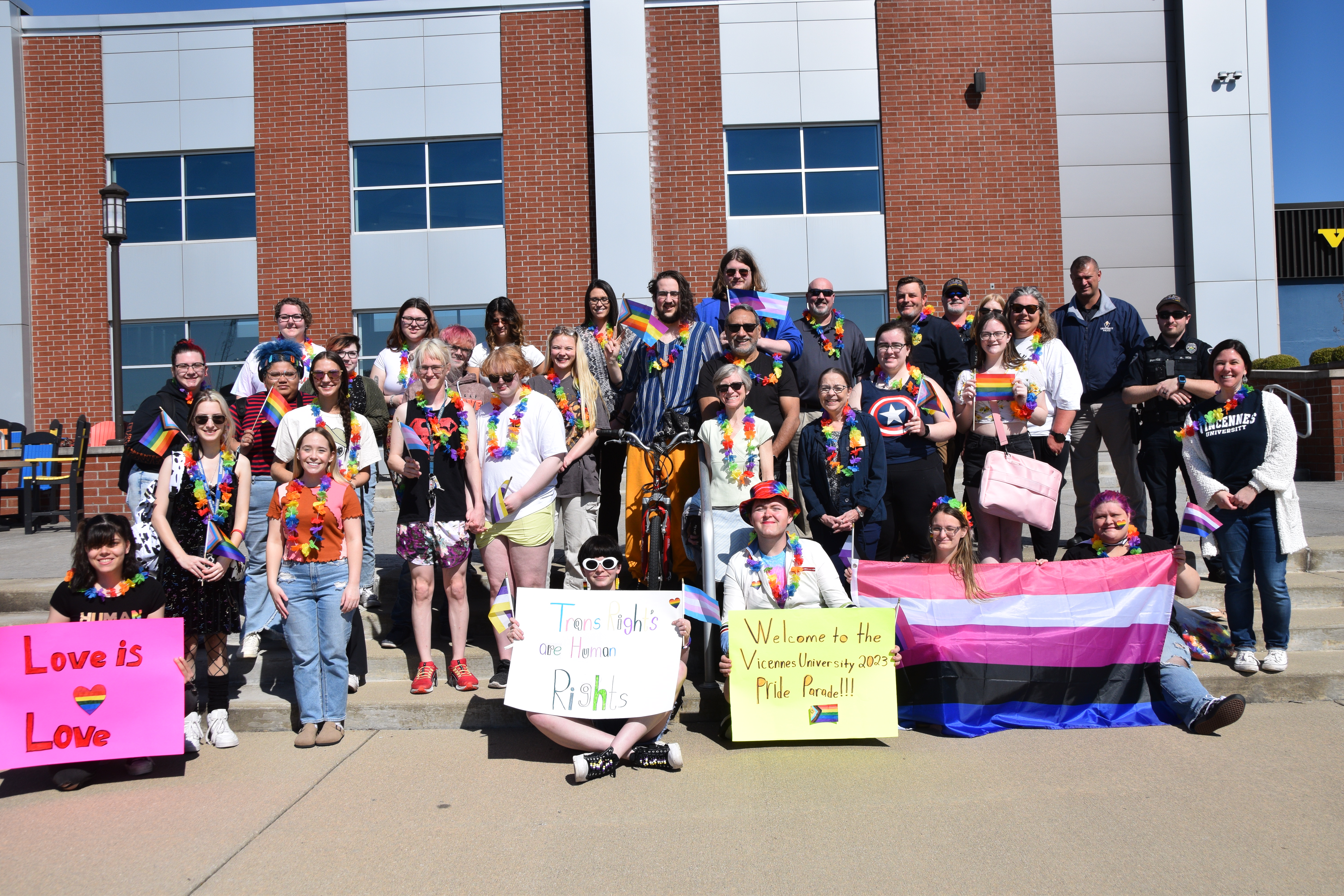 Students, faculty, and staff pose for a photo at the end of the Pride Walk in front of Jefferson Student Union.