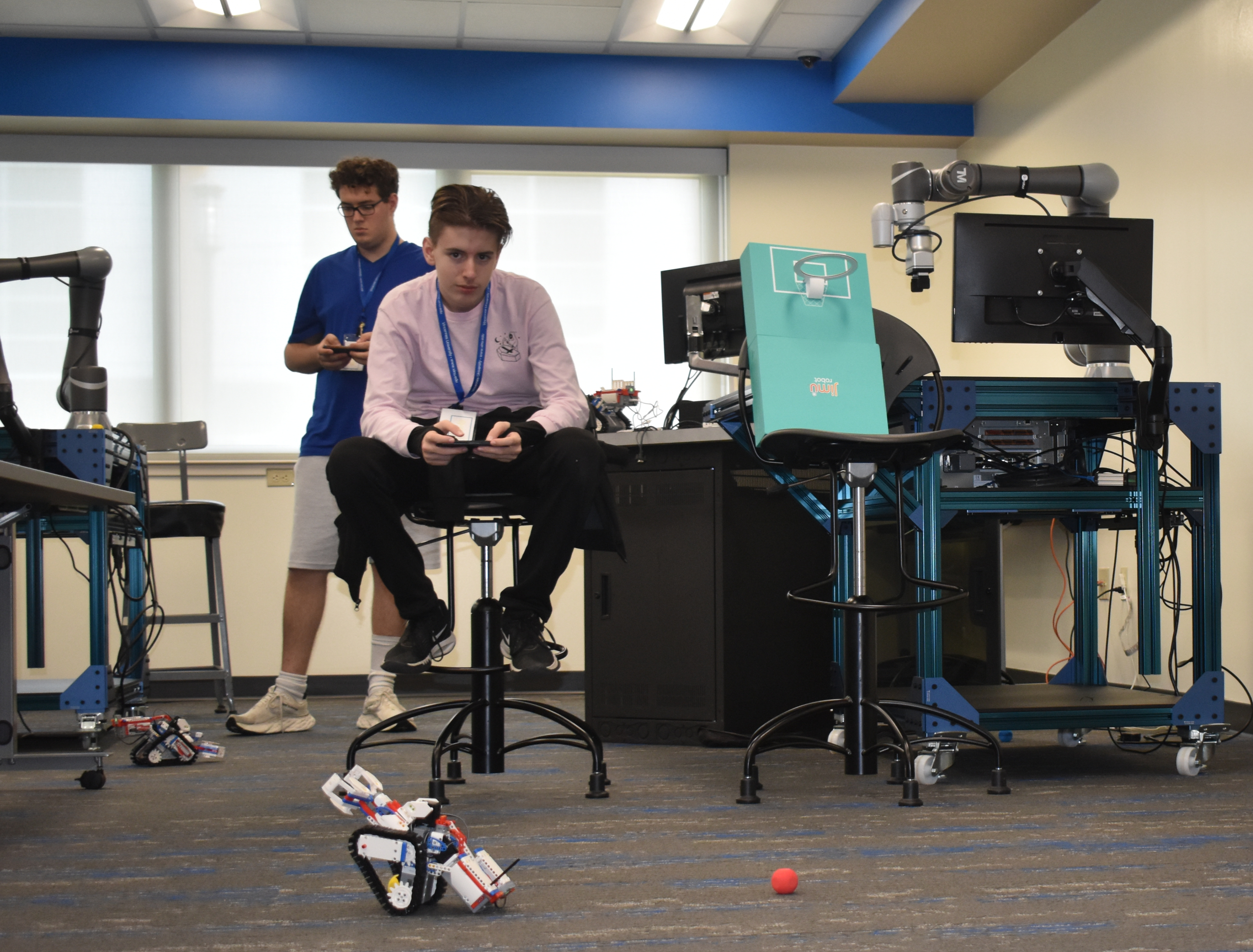High school students operate the champ bot robots they built and programmed.