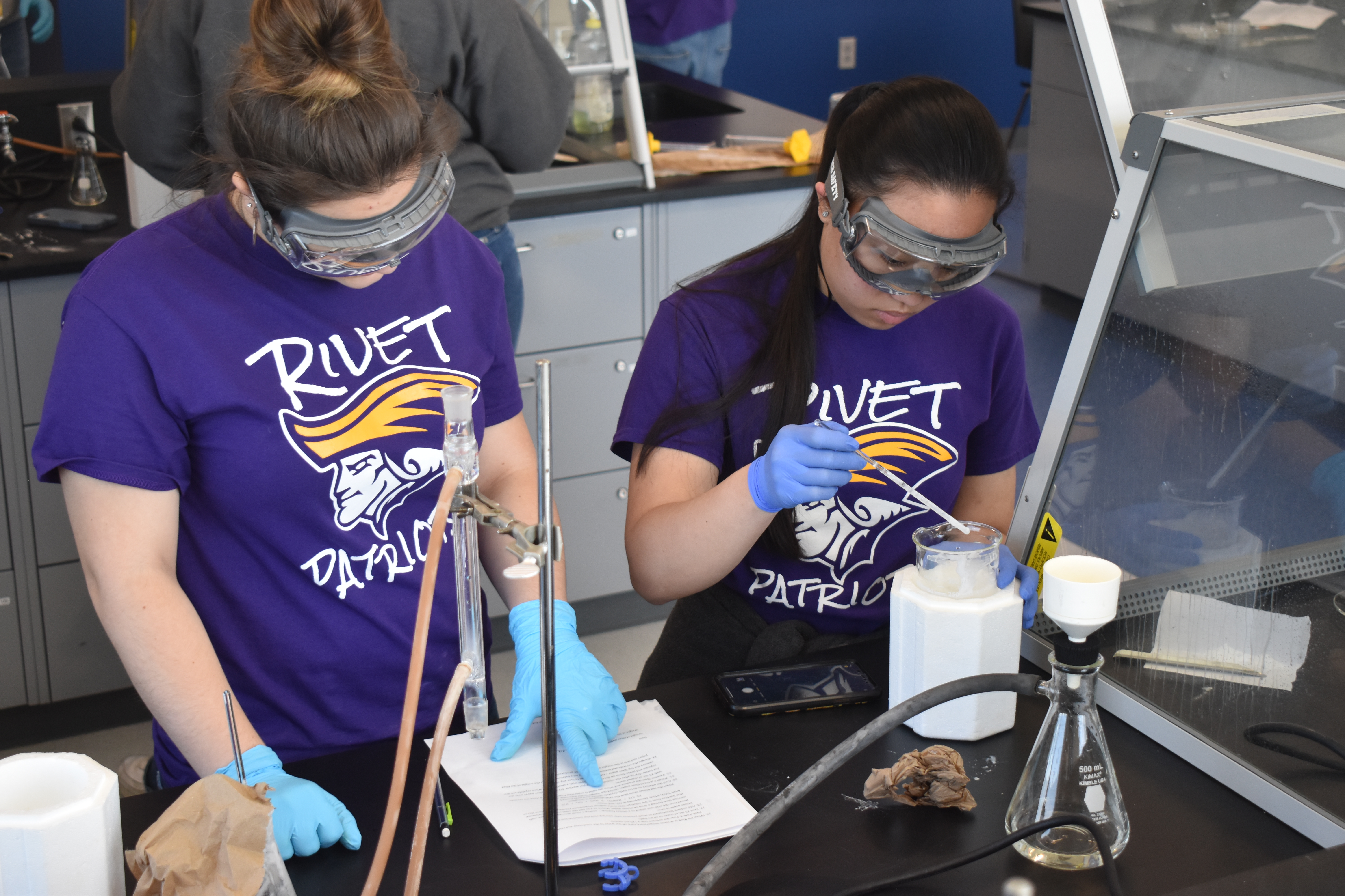 Two female students from Rivet High School make an antibiotic in a Chemistry Lab at Updike Hall.